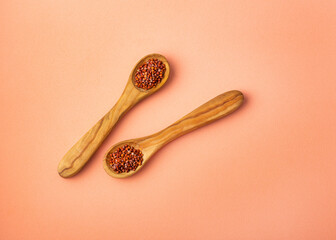Chenopodium quinoa - Red quinoa seeds in two wooden spoons