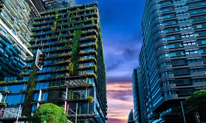 Tuinposter Apartment block in Sydney NSW Australia with hanging gardens and plants on exterior of the building at Sunset with lovely colourful clouds in the sky © Elias Bitar