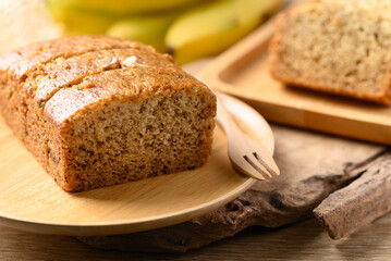 Banana bread on wooden plate with fork ready to eating