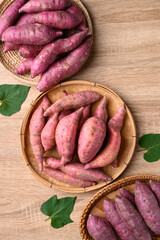 Various sweet potato in basket on wooden background