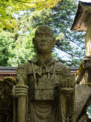 Stone statue of a Buddhist monk in a mountain temple in Japan
