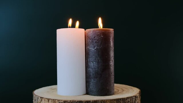 advent candle. Christmas advent four candles. Four burning wax candles on a wooden cut on dark green background.Rotation. High quality 4k footage