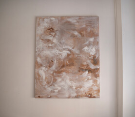 Decor. Modern art. Closeup view of an abstract painting hanging from the white wall.