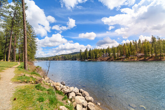 Waterfront luxury homes in the mountains of North Idaho along the Spokane River viewed from the public Kiwanis Park in the rural town of Post Falls, Idaho, USA.
