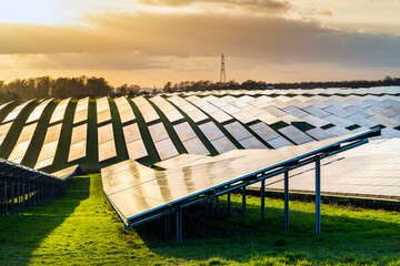 UK Solar Park at sunset,vibrant golden sunlight reflecting from panels,Hampshire,England,United...