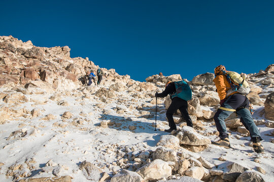 group of mountaineers walking through the mountain full of snow and rocks in the morning in Iztaccihuatl - Popocatepetl National Park