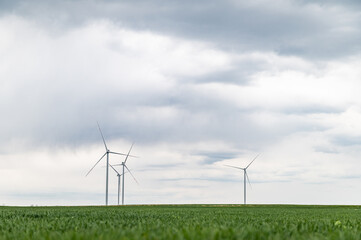 Three wind turbines of a wind farm, producing renewable energy. Clean green alternative power. Wind energy to fight climate change and global warming.No fossil fuels or emissions.Earth day for planet.