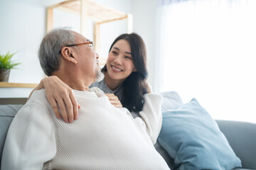 Asian lovely family, young daughter greeting and hugging older father. 