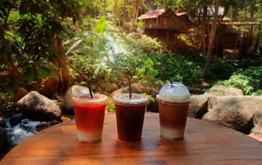 glasses of iced coffee and Thai milk tea on wooden table