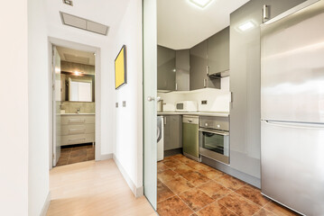 kitchen with sliding glass partition, gray furniture with integrated appliances