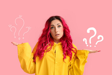 Helpless woman in raincoat on pink background