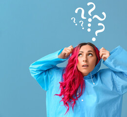 Woman in raincoat and question marks on blue background