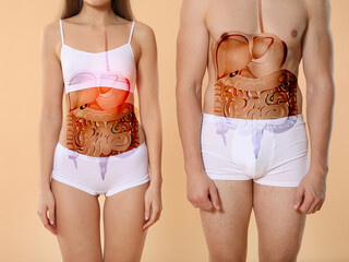 Young man and woman with drawn digestive system on color background