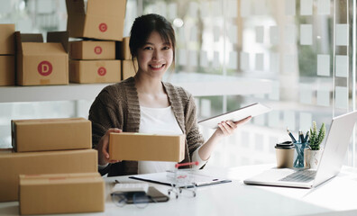 Startup small business entrepreneur SME, asian woman packing cloth in box. Portrait young Asian...
