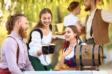 People with beer celebrating Octoberfest outdoors