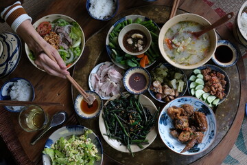 Close view of traditional vietnamese meal chicken vegetable pork and rice decorated in wooden background 
