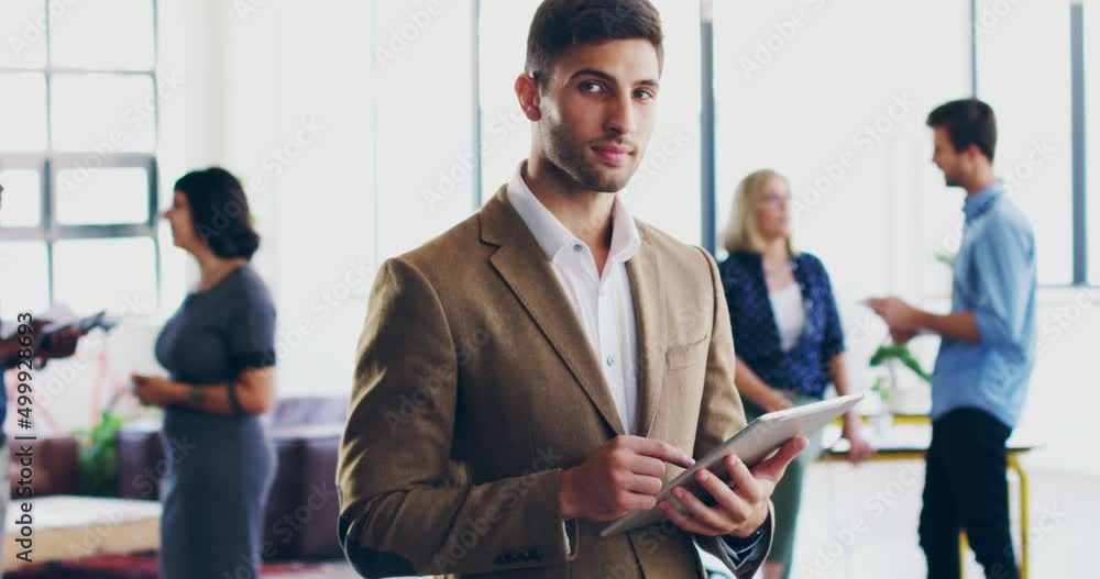 Poster hes most certainly going places in the company. 4k video footage of a young man using a digital tabl