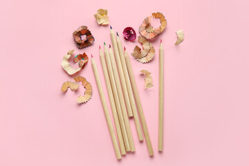 Colorful pencils and shavings on pink background