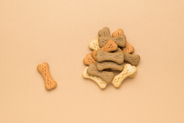 Dog cereal cookies in the form of seeds on a beige background. Flat lay.