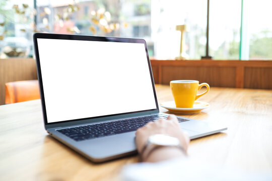 Mockup image of a woman using and working on laptop computer with blank white desktop screen