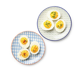 Plates with tasty stuffed eggs on white background. Easter celebration