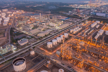 Fototapeta na wymiar Aerial view of petrochemical oil refinery and sea in industrial engineering concept in Bangna district at night, Bangkok City, Thailand. Oil and gas tanks pipelines in industry. Modern metal factory.