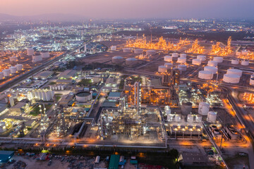 Obraz na płótnie Canvas Aerial view of petrochemical oil refinery and sea in industrial engineering concept in Bangna district at night, Bangkok City, Thailand. Oil and gas tanks pipelines in industry. Modern metal factory.