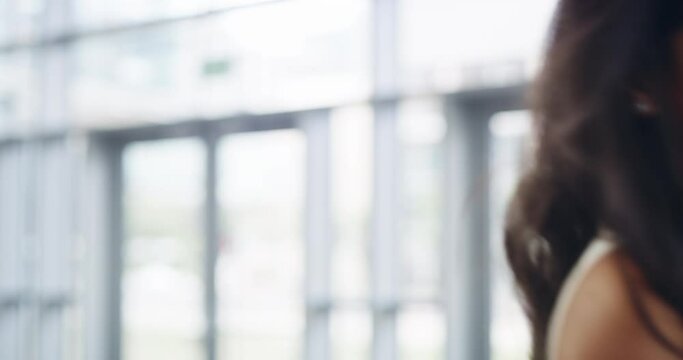First rule of success, keep it real. 4k video footage of a young businesswoman showing a shaka hand sign while walking through a modern office.