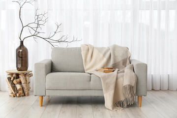 Interior of living room with grey sofa near window