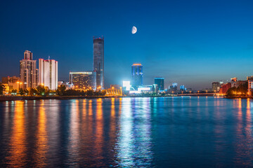 Fototapeta premium Night with big moon on a pond in the center of the city. Yekaterinburg city and pond at night.