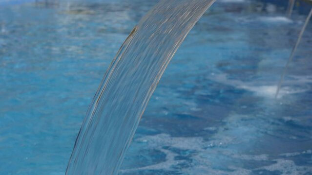 Fresh water jet of a swimming pool. Regenerating jet. Health centre. General context of water jet. Relaxing setting of a spa with swimming pool