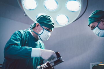 Medical urgency doctor using defibrillator during surgical operation a patient in hospital operating room