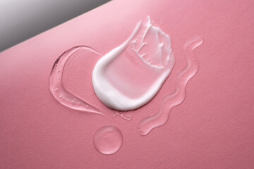 Serum and cream on a pink background. Textures.