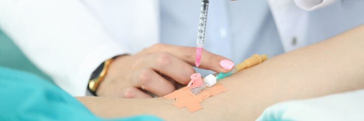 Doctors hands place dropper in patients hand