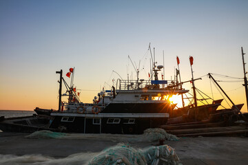 Fototapeta premium Wooden fishing boats on the coast in the evening