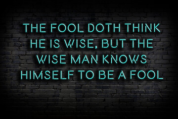 Smart and motivational quotation. Neon sign on brick wall