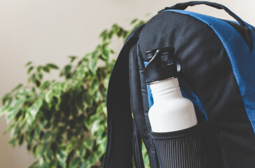 Stainless steel reusable water bottle in backpack side pocket