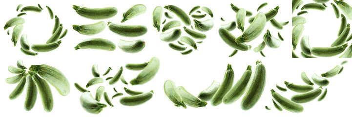 A set of photos. Green zucchini levitate on a white background