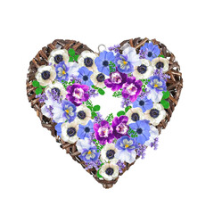 Wedding wicker wreath in the shape of a heart. Spring flower decoration. White and blue anemones, blue pansies, purple orchids, lavender and clover.