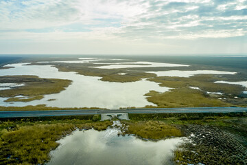 asphalt road and bridge over a lake in the steppe photo from a quadcopter landscape