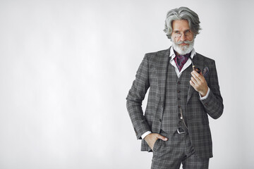 Elegant senior man with a smoking pipe