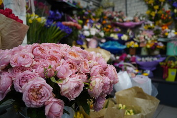 Bright bouquets of flowers with decorative paper on sale.