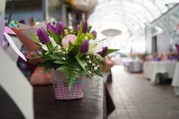 Bright bouquets of flowers with decorative paper on sale.