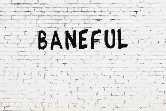 Inscription baneful painted on white brick wall