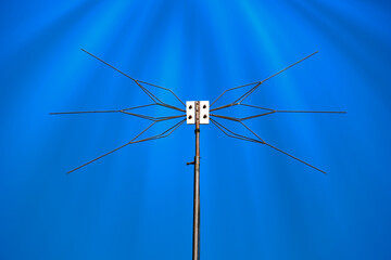 Antenna on a blue sky background . Metal radio antenna close - up .