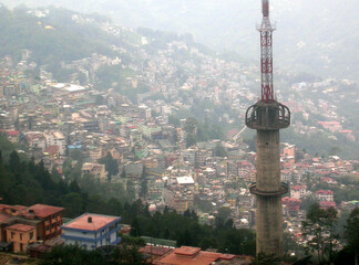 Fototapeta premium A panoramic view of Gangtok city with concrete jungle amid TV Tower as seen from Ganesh Tok in Gangtok, Sikkim. Sikkim comes under 4th seismic zone in India so high buildings is banned here.