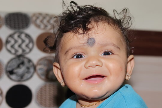 portrait photo of A lovely cute little Indian hindu baby boy looking at the camera with smiling face, india