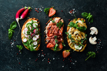 Three delicious colored homemade sandwiches. On a stone background. Top view.