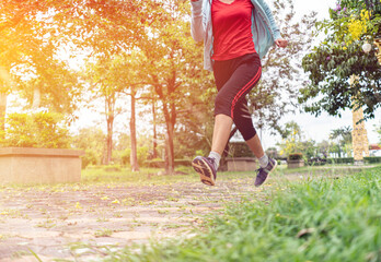 Fit young woman running in park.Running woman atletic spotsman trains in the summer park. Outdoor fitness portrait
