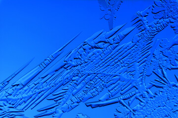 Gold patterns from frost on glass as a background.